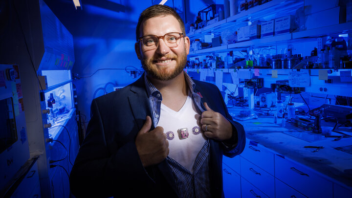 Eric Markvicka, Krohn Assistant Professor of Biomedical Engineering, displays the wearable monitoring device he is helping develop. The device is attached to his undershirt.