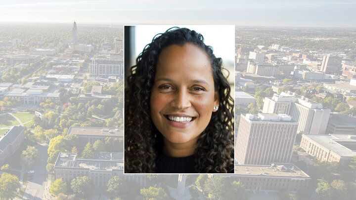 Color portrait of Noelle Russell, founder and chief AI officer of the AI Leadership Institute, on a color campus background.