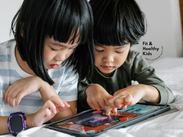 Two youth working on a digital tablet together