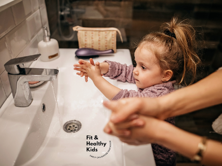 Parent and child washing hands at the sink