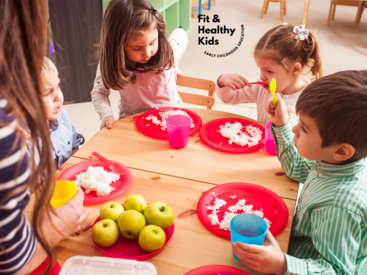 Children gathered at table eating family style