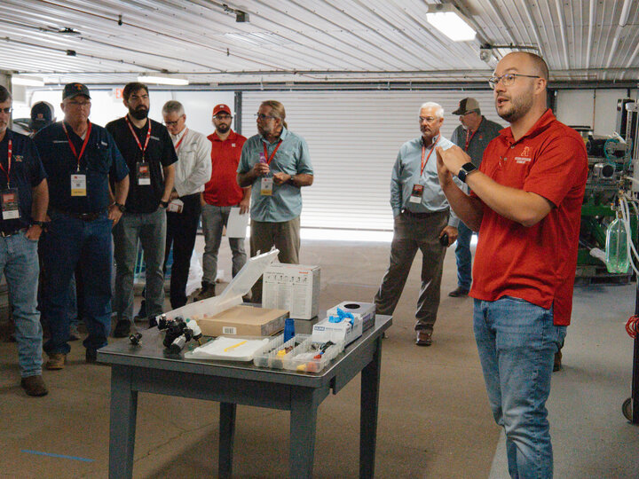Milos Zaric presenting to a group of precision agriculture producers on different nozzles for spraying pesticide