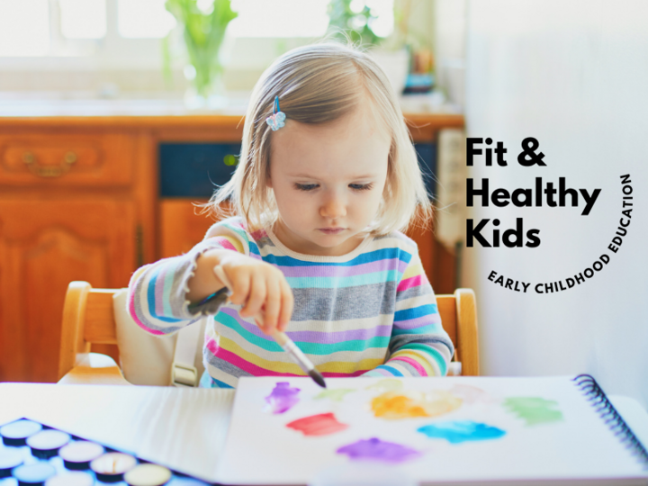 Young child painting at table