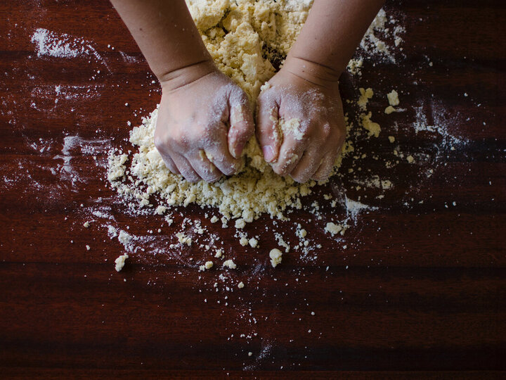 Hands working on bread dough