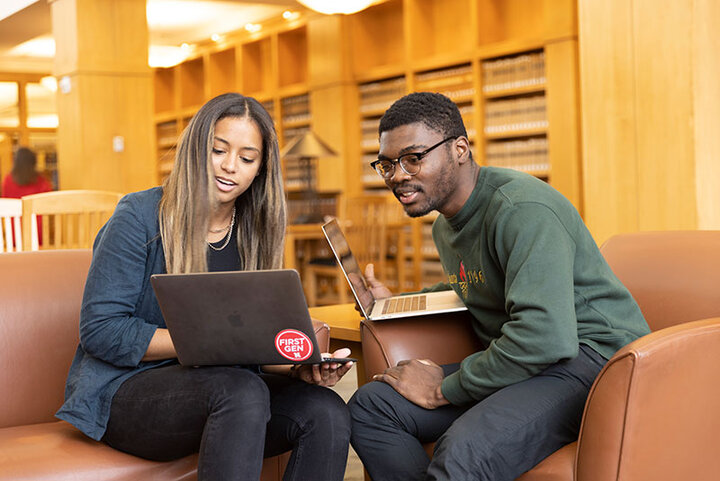 law students sitting in library with laptop looking at same screen